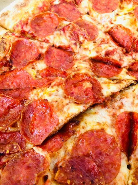 Delicious pepperoni pizza slices served fresh from the oven during a casual dining experience